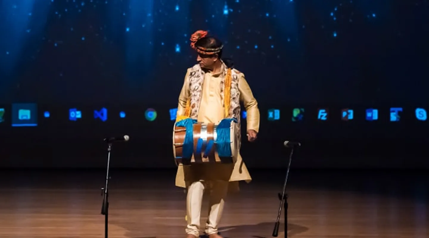 An artist playing the dhol