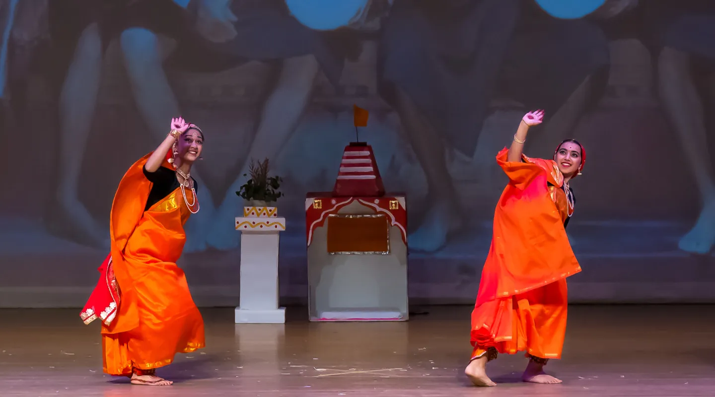 Students in colorful Kodava attire on stage